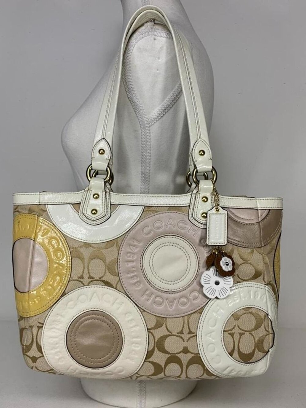 Coach handbag with beige and cream circular logo